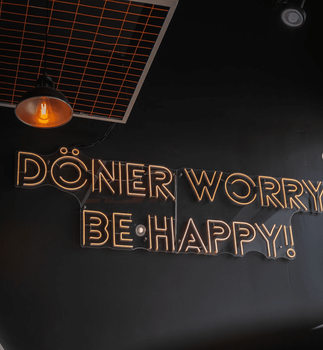 Happy customers enjoying döner at the shop